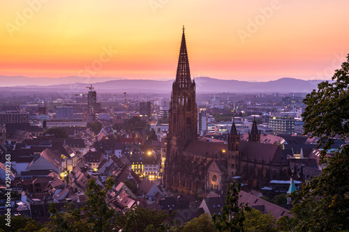 Germany, Amazing red sky sunset over medieval city freiburg im breisgau cathedral and skyline from above in summer