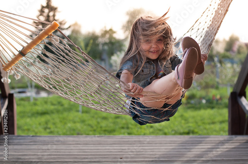 Laughing child having fun on swing
