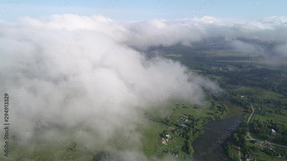 Very slow and smooth flight above the clouds. Slow decrease in height, followed by flying into the cloud.