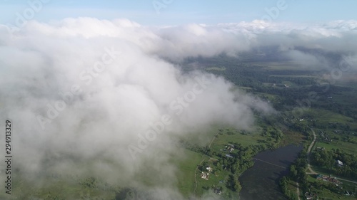 Very slow and smooth flight above the clouds. Slow decrease in height  followed by flying into the cloud.