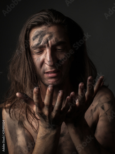 Portrait of unhappy young man with dirty skin