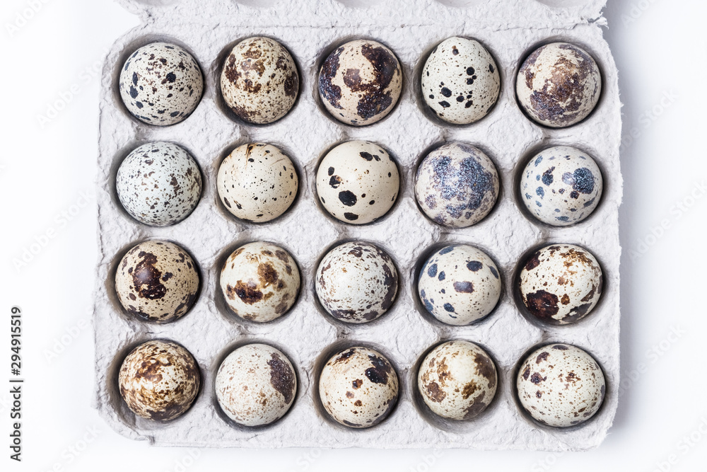 cardboard box with quail eggs on a white table cardboard box with quail eggs on a white table
