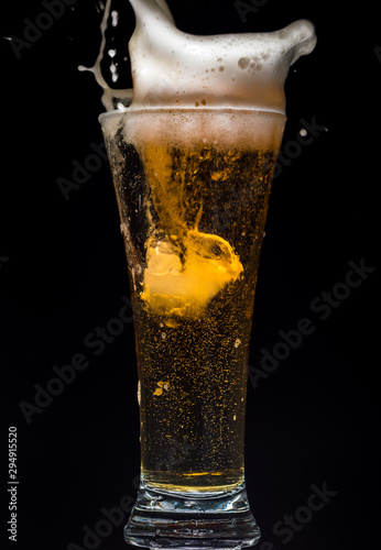 Wallpaper Mural Glass of beer with foam on a black background in the dark Torontodigital.ca