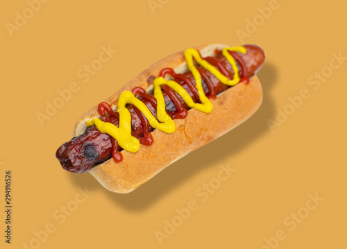 Fotografia, Obraz Hot dog with mustard on yellow background.