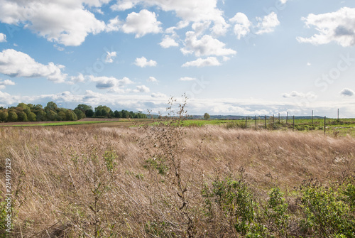 Cloudy sky over a harvested field in October.