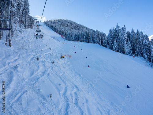 BANSKO, BULGARIA - January 2017 - Lift with tourist travel to snow top. Bansko is a ski resort in southwestern Bulgaria. © ikmerc