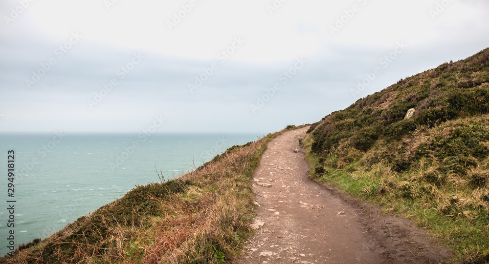 hiking trail on cliff skirting the sea in Howth