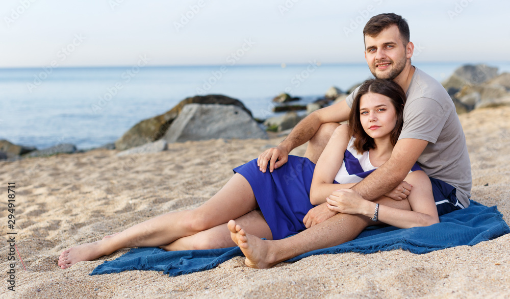 Fototapeta premium Positive loving couple resting and hugging