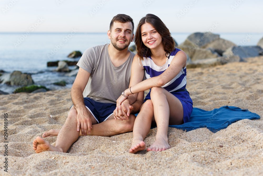 Fototapeta premium Happy loving couple sitting and hugging