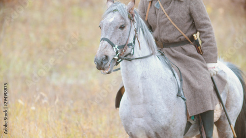 A millitary man riding on the back of the horse on the field