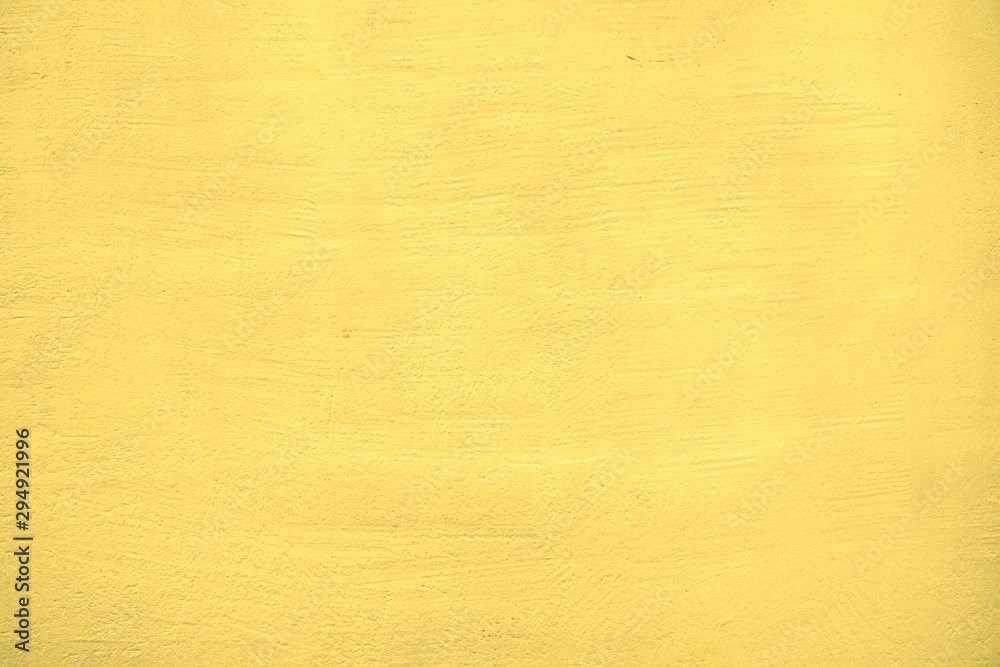 Fototapeta premium Texture of a plastered yellow wall.