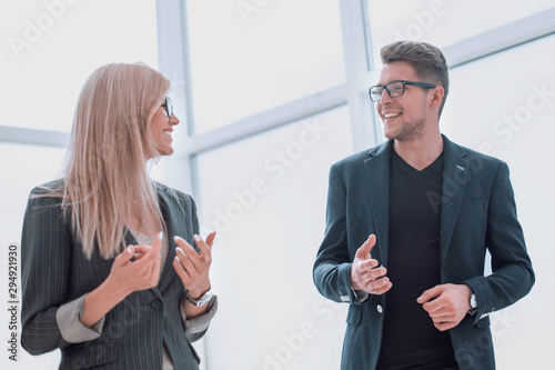 business couple discussing something standing in the office