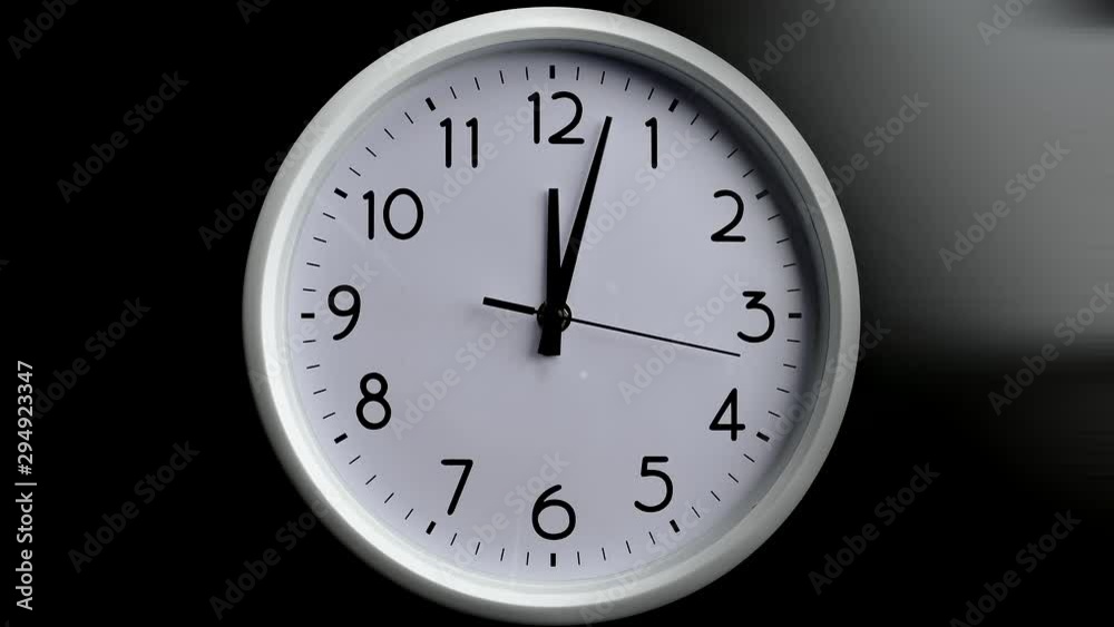 Watch close-up. Time is running fast. Hour minute and second hand. Wall clock on a black background. Watch close-up. Time is running fast. Hour minute and second hand. Wall clock on a black background.