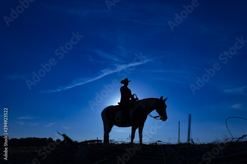 Silhouette cowgirl on horse at sunrise in blue (4)