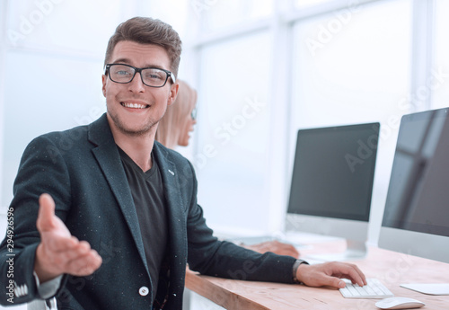young employee sitting at his Desk in the office