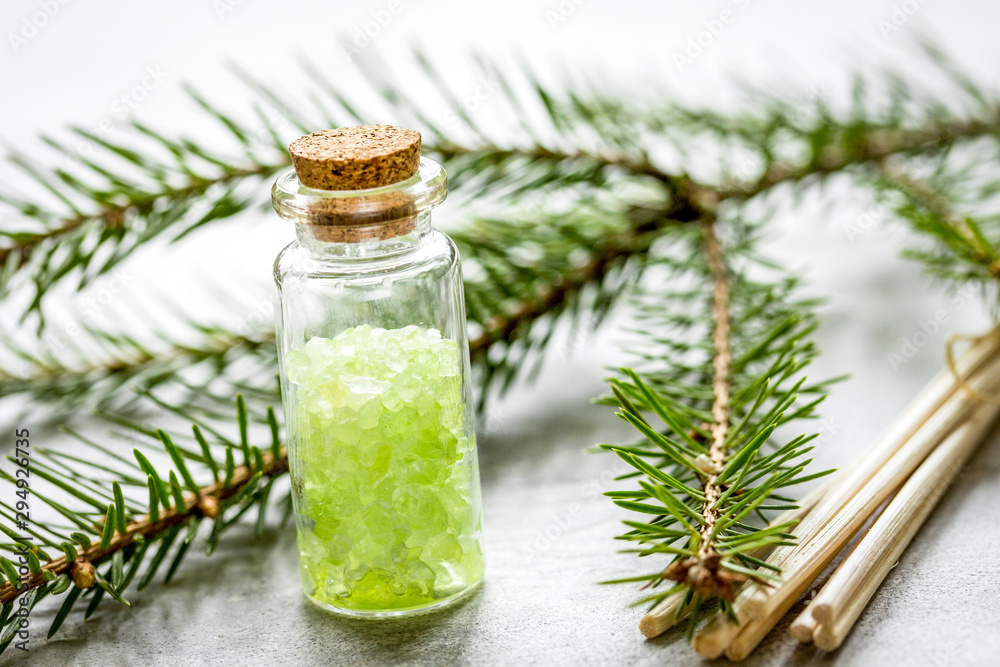 fir branches and spruce bath salt on white table background fir branches and spruce bath salt on white table background