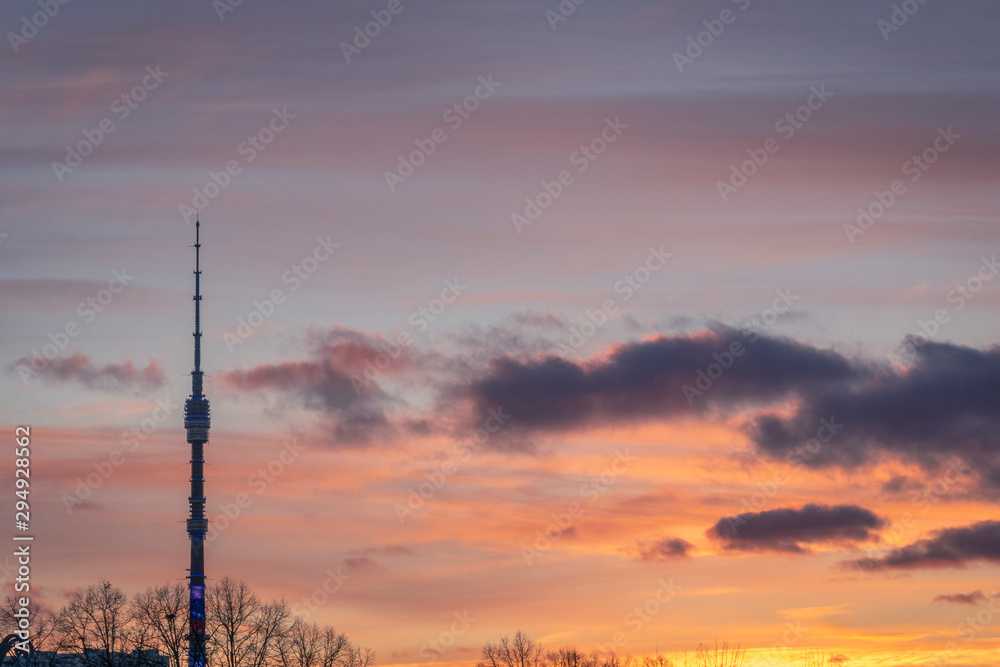 Television tower Ostankino in Moscow against sunset cloudy sky in background. TV tower.