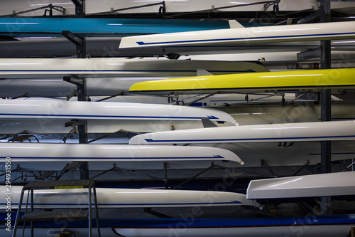 Foto Stacks Of Gleaming White Crew Rowing Shells In A Boathouse