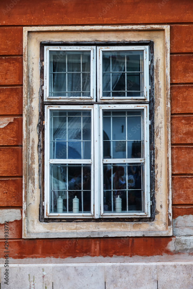 Old window with frames on the wooden wall of the rural house Old window with frames on the wooden wall of the rural house