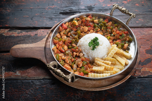 Obraz na plátně Turkish food lamb meat saute, sac kavurma with rice and french fries isolated on