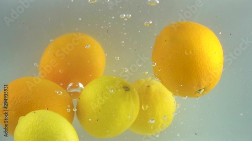 Fruits with oranges poured into clear water.