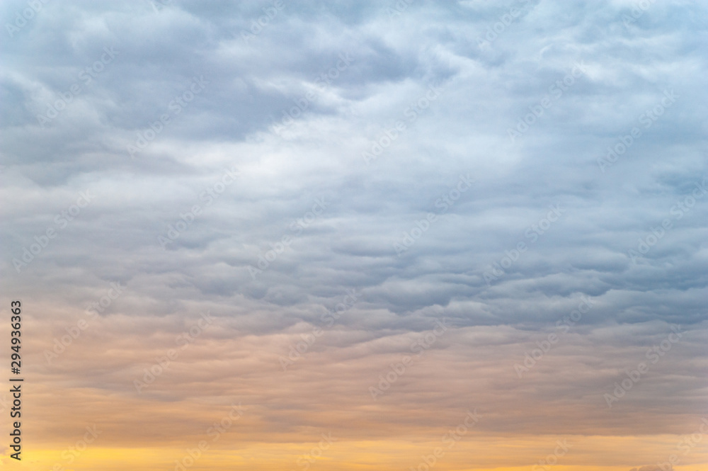 A lot of dark clouds. Cloudy rainy windy sky in the evening at sunset.