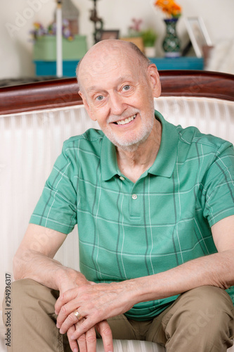 Senior Man Smiling on Couch at Home