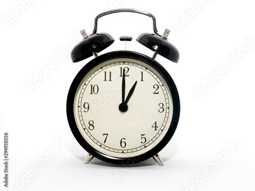 Old-style alarm clock, black and white, it's one o'clock.