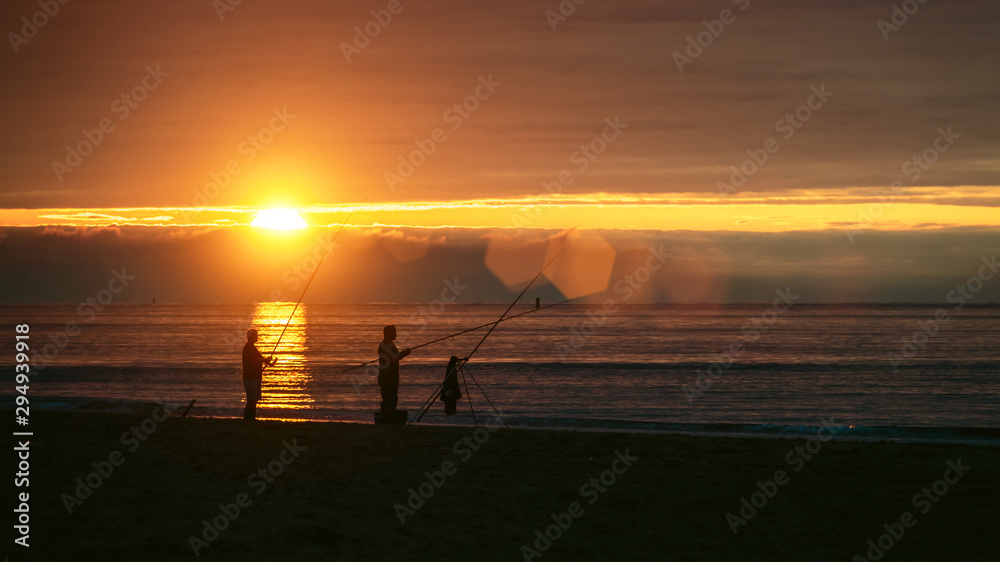 Anglers at the beach at sunset