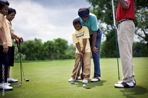 Family playing golf together