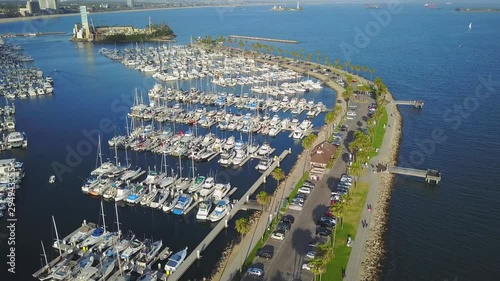 Aerial view above long beach marina sail boats moored along jetty harbour coastline. Los Angeles, California. photo