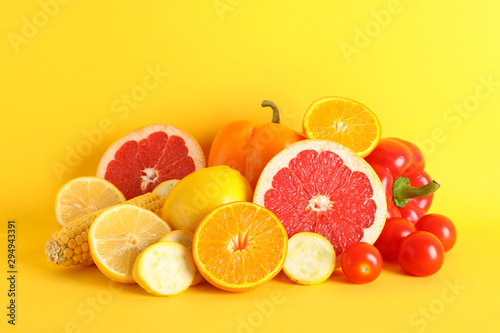 Different vegetables and fruits on yellow background  copy space