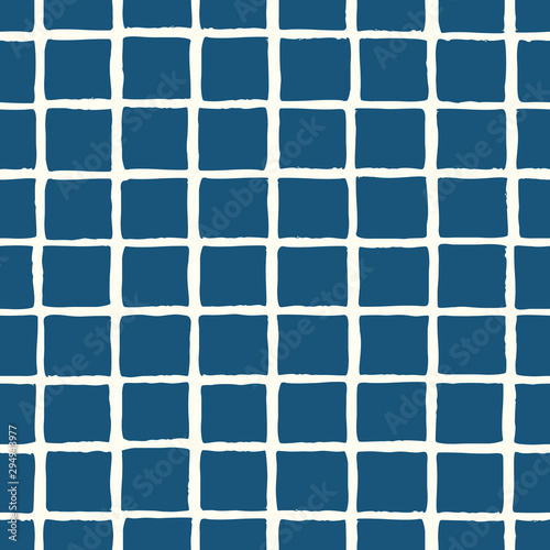 Hand painted seamless pattern with a grid in blue on cream background.