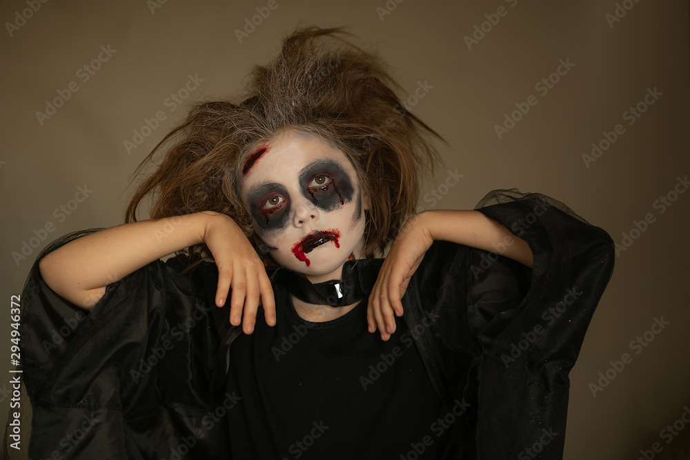 Children in carnival costumes with scary face painting on Halloween. Black  background. Stock Photo