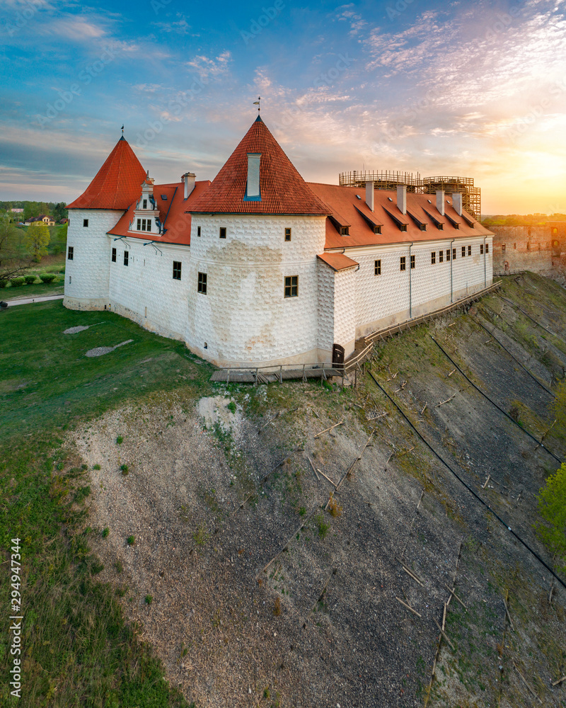 Naklejka premium Bauska town aerial panorama with Bauska medieval castle in sunset.