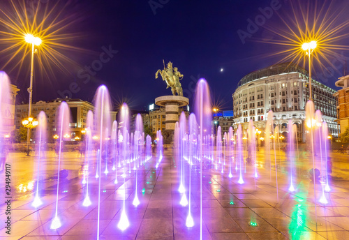 Square Macedonia in Skopje at night with dancing illuminated fountains and statue of Alexander the Great (warrior on horse) at background © stoimilov