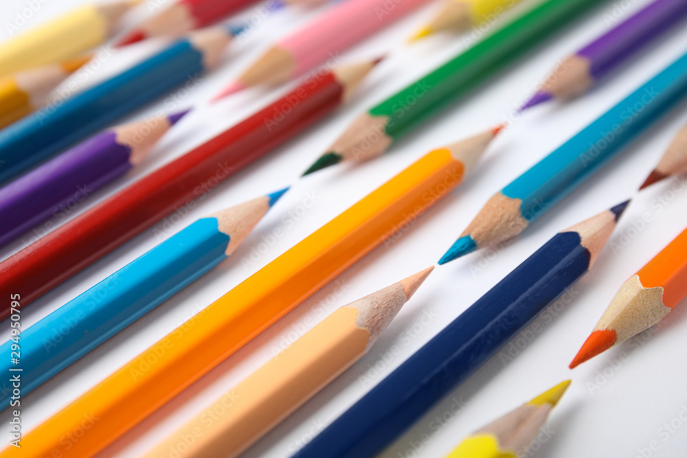 Composition with color pencils on white background, closeup