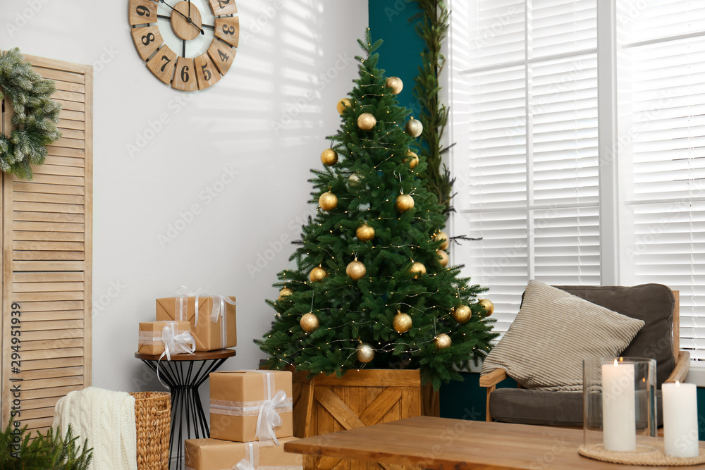 Beautiful decorated Christmas tree in living room interior