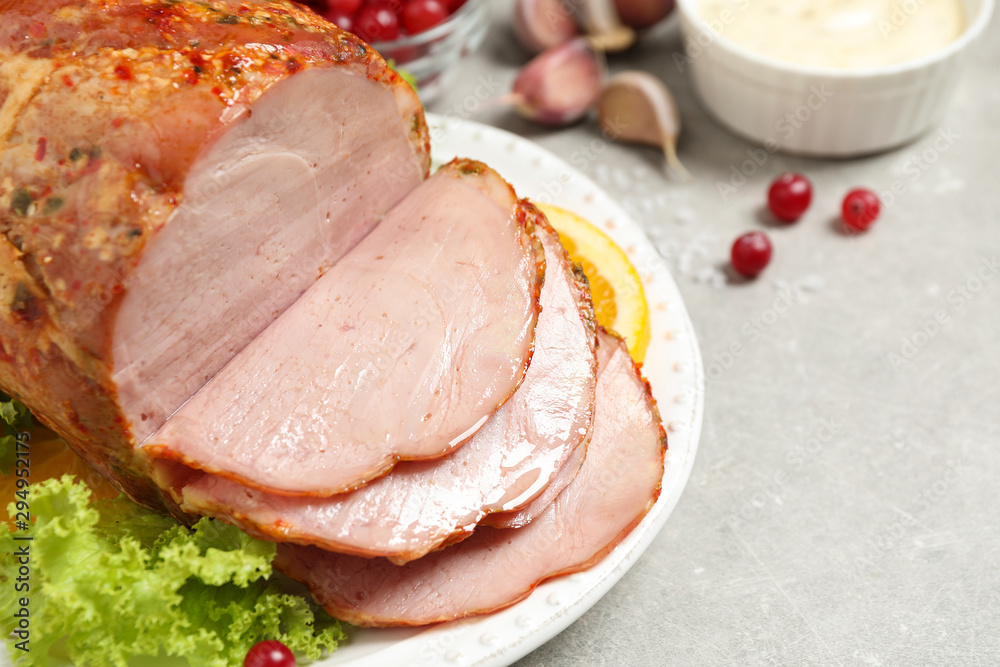 Delicious ham served with garnish on grey table, closeup