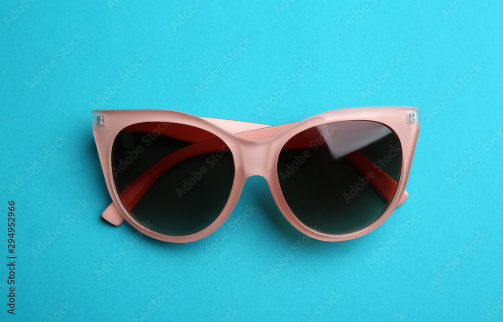 Stylish sunglasses on blue background. Fashionable accessory Stylish sunglasses on blue background. Fashionable accessory