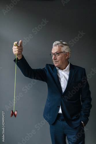 Senior businessman playing with yoyo