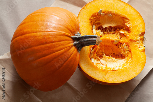 Cut open pumpkin with seeds for Halloween Thanksgiving or autumn themes shot from above in natural light