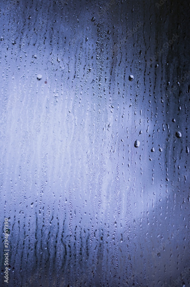 Fog and raindrops on window glass, dark background and lantern l Fog and raindrops on window glass, dark background and lantern l