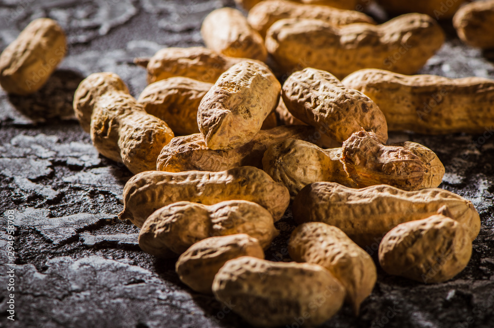Fototapeta premium Dried peanuts or nuts on wooden background.peanut on wooden background, Peanuts seed, composition of peanuts serving to make oil, peanut butter