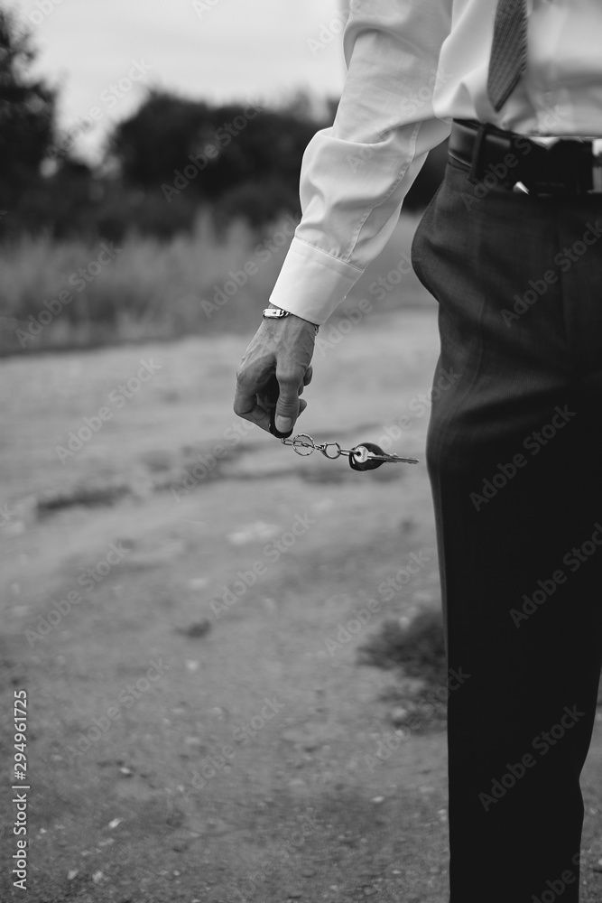 Obraz premium man holds car keys in his hand, black and white image