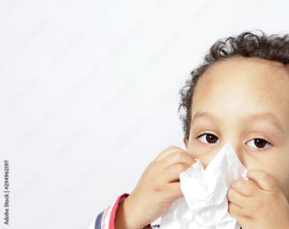 child blowing nose after catching a cold with white background stock photo child blowing nose after catching a cold with white background stock photo