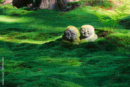 The moss garden and stone statues in the Sanzenin temple, Ohara, Kyoto, Japan photo