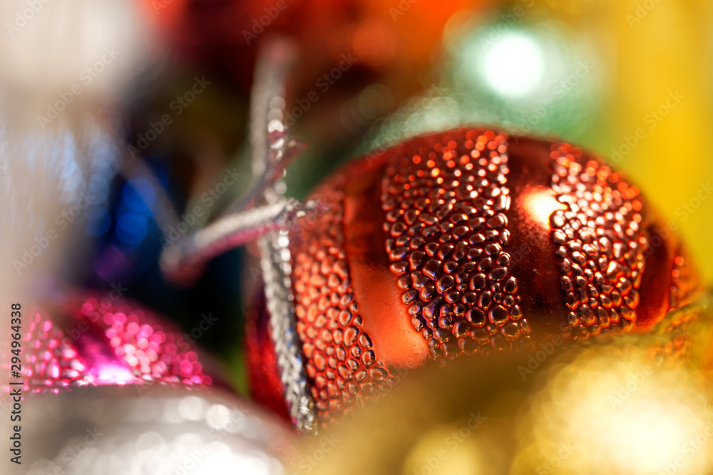 Bright and colorful Christmas toys in a box for decorations. Close-up. Preparing for the New Year holidays. Macro. Bokeh, volume and shallow depth of field