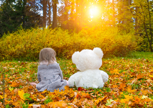 Wallpaper Mural Little girl and toy bear on the autumn lawn Torontodigital.ca