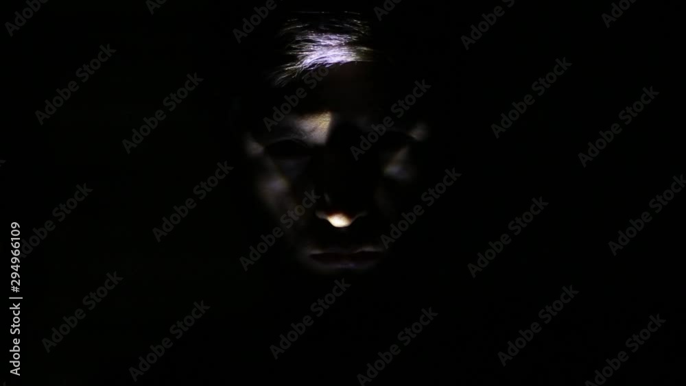 Dark portrait of creepy face selected with light. Dark portrait of creepy face selected with light.